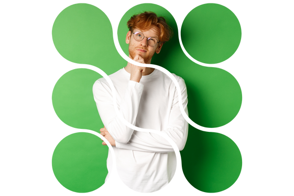A red-haired man with glasses gives a contemplative look upward against a green background